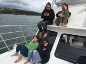 students on bow of boat